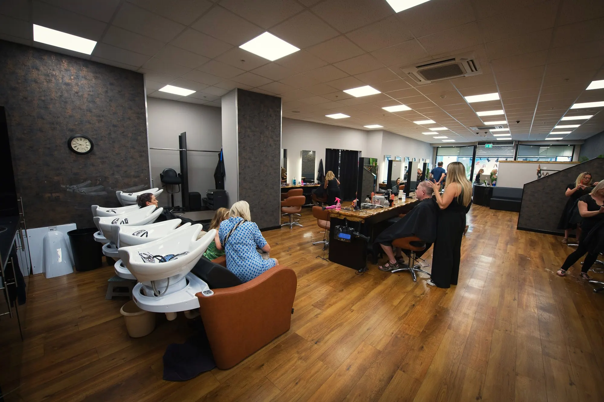 Clients at the backwash basins at Deesigner Hair Studio, Ipswich
