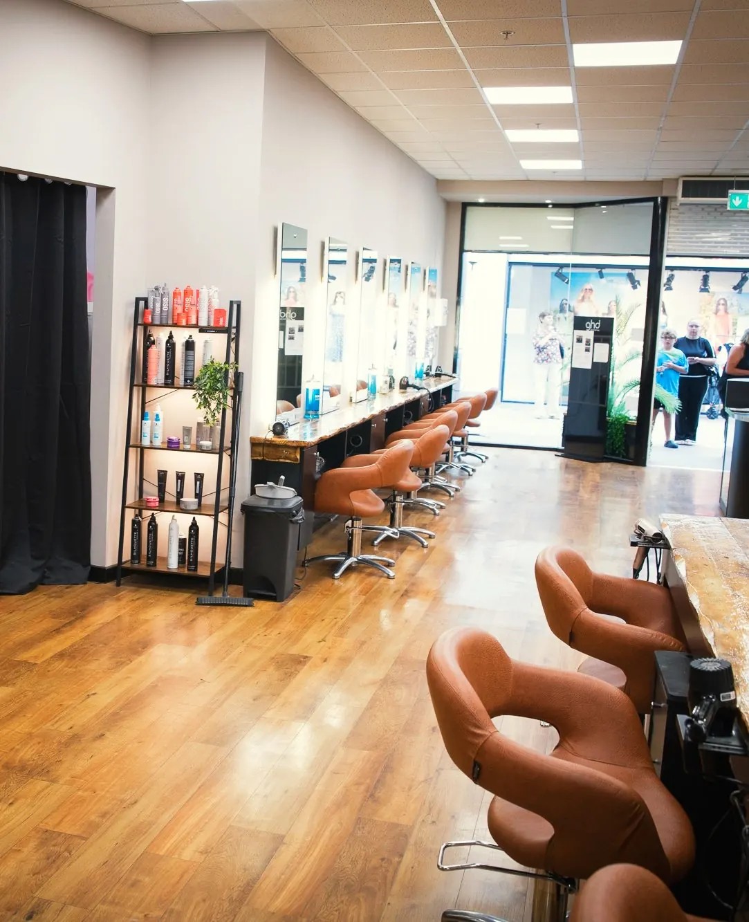 The length of the salon floor at Deesigner Hair Studio, Ipswich, looking through to the shopfront